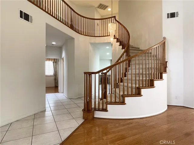 a view of an empty room with a fireplace and a window