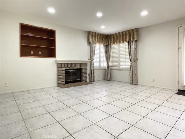 a kitchen with granite countertop a table chairs microwave and cabinets