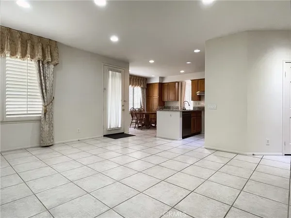 a kitchen with stainless steel appliances granite countertop a sink a stove a dining table and chairs