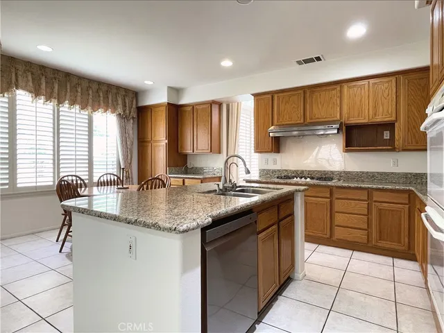 a kitchen with stainless steel appliances granite countertop a sink and a counter