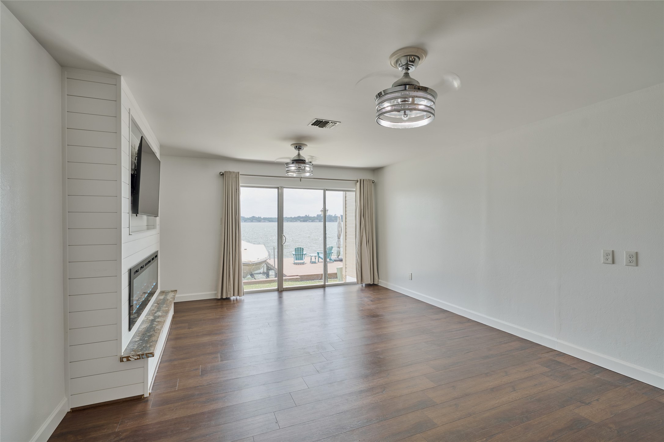 801 River Road, Unit E111 Montgomery, TX 77356 - Photo 4 of 24 wooden floor in an empty room with a window