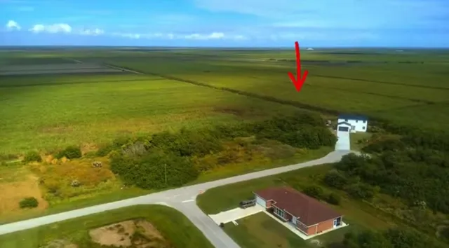 a view of a swimming pool with a yard