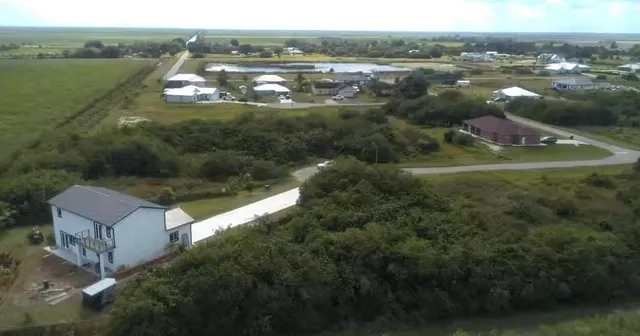 an aerial view of house with yard and lake view