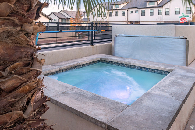 2600 Ocotillo Way, Unit 31 Santa Clara, UT 84765 - Photo 4 of 73 In-ground spa with stone coping and blue tile surround