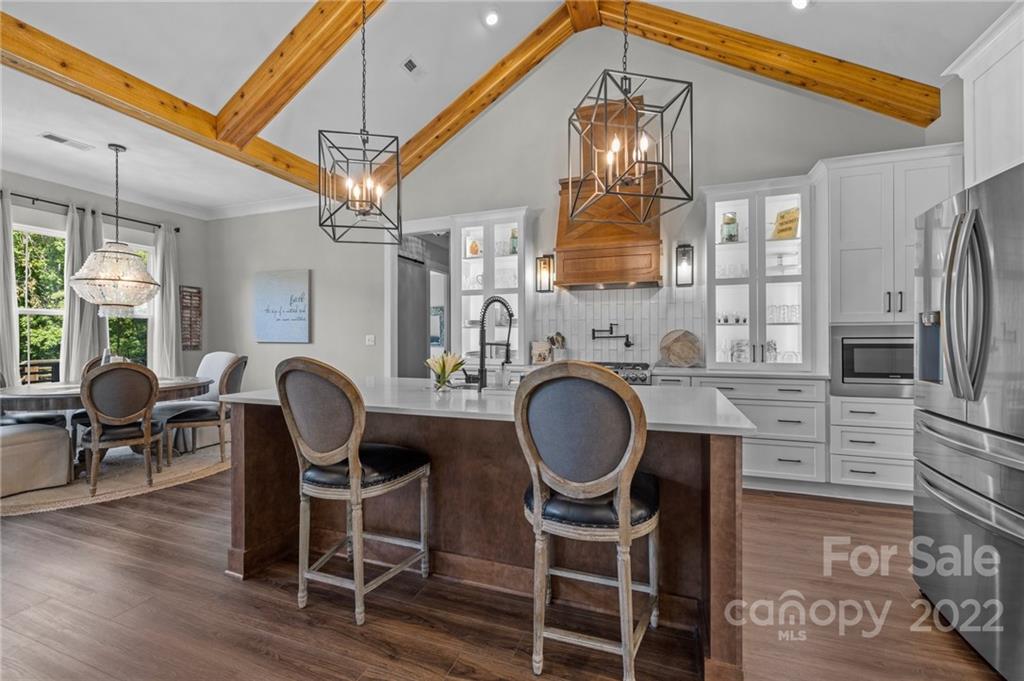 11099 Pheasant Run Tega Cay, SC 29708 - Photo 14 of 47 a dining room with furniture a chandelier and wooden floor