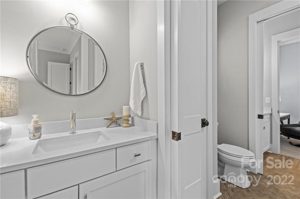 11099 Pheasant Run Tega Cay, SC 29708 - Photo 22 of 47 a bathroom with a toilet a sink and a mirror