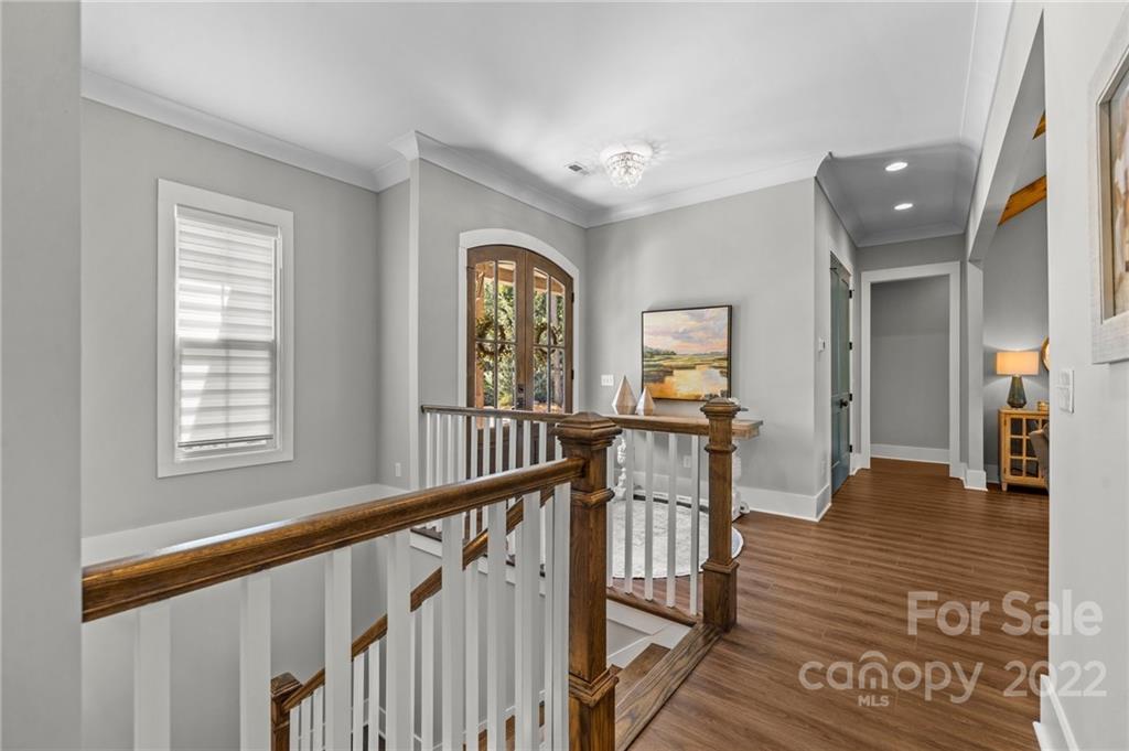 11099 Pheasant Run Tega Cay, SC 29708 - Photo 31 of 47 a view of a hallway with wooden floor and windows