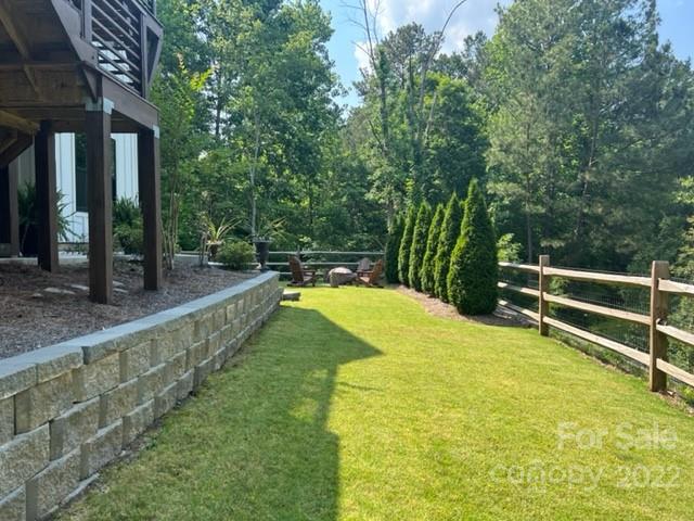 11099 Pheasant Run Tega Cay, SC 29708 - Photo 43 of 47 a view of swimming pool with lawn chairs and large trees