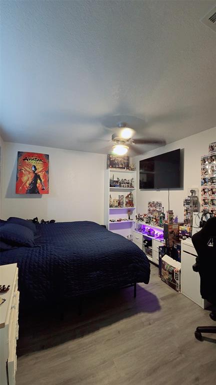 2240 Tarpley Road, Unit 134 Carrollton, TX 75006 - Photo 19 of 23 a bedroom with furniture and a bed