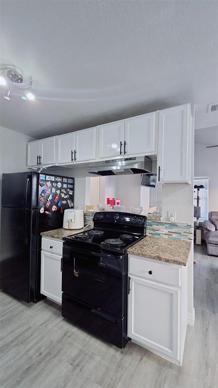2240 Tarpley Road, Unit 134 Carrollton, TX 75006 - Photo 4 of 23 a kitchen with stainless steel appliances granite countertop a stove top oven a refrigerator a sink and dishwasher with white cabinets