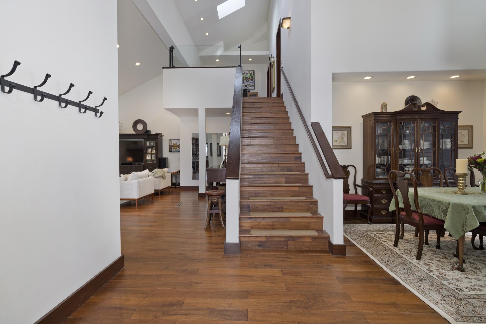 310 Ranch Road Mammoth Lakes, CA 93546 - Photo 12 of 40 Staircase with a high ceiling, wood finished floors, recessed lighting, and a skylight