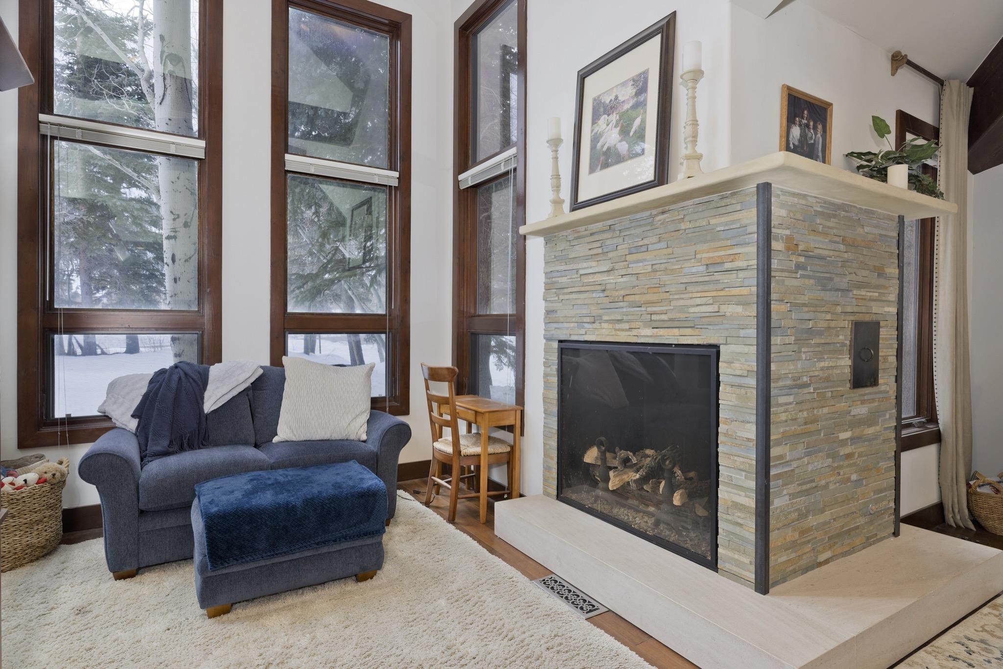 310 Ranch Road Mammoth Lakes, CA 93546 - Photo 16 of 40 Living area featuring a stone fireplace and wood finished floors