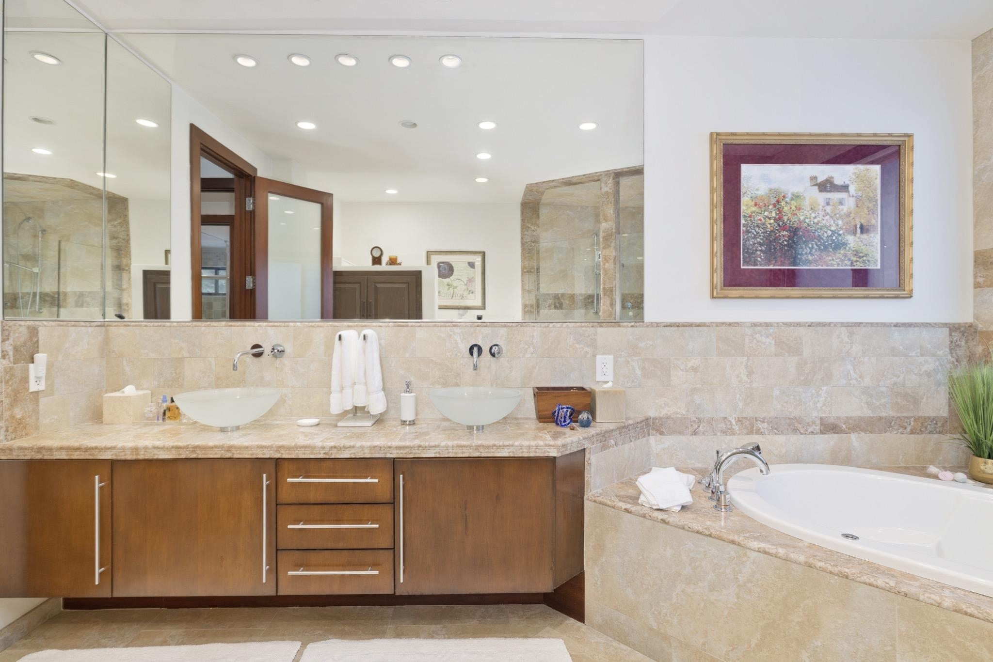 310 Ranch Road Mammoth Lakes, CA 93546 - Photo 19 of 40 Bathroom featuring double vanity, a bath, tile walls, tiled shower, and decorative backsplash