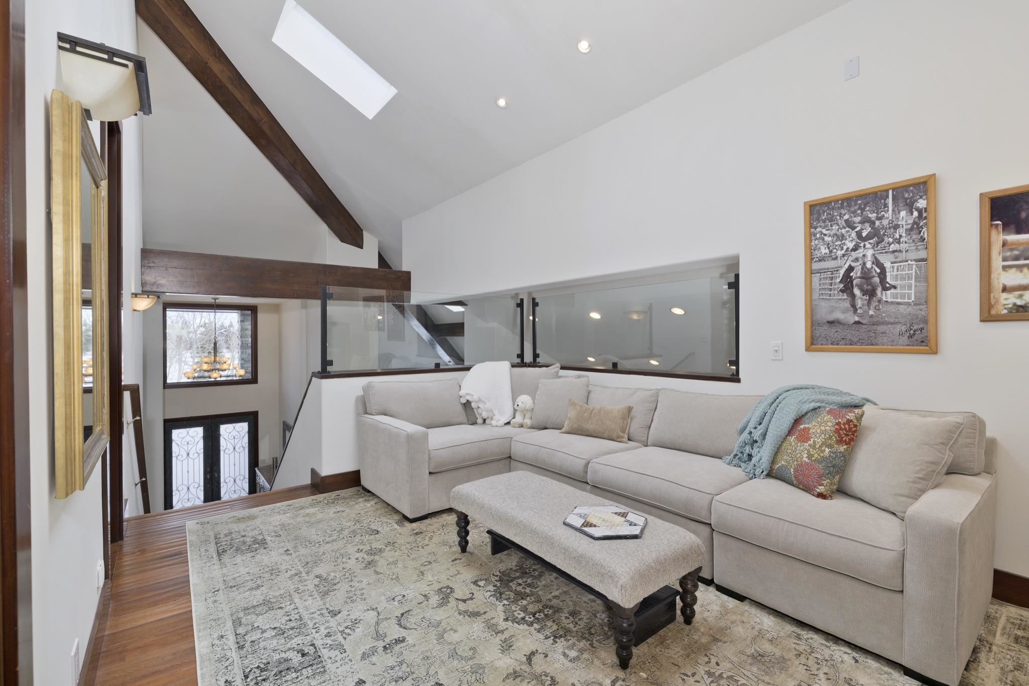 310 Ranch Road Mammoth Lakes, CA 93546 - Photo 29 of 40 Living room featuring high vaulted ceiling, a skylight, wood finished floors, recessed lighting, and beamed ceiling