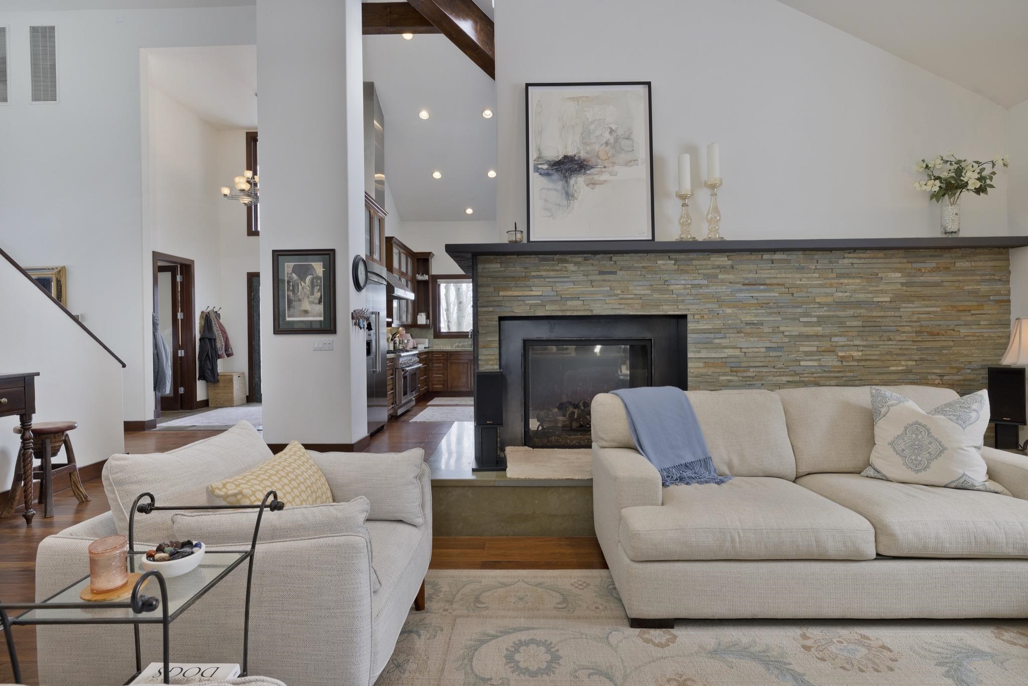 310 Ranch Road Mammoth Lakes, CA 93546 - Photo 4 of 40 Living room with high vaulted ceiling, a stone fireplace, and wood finished floors