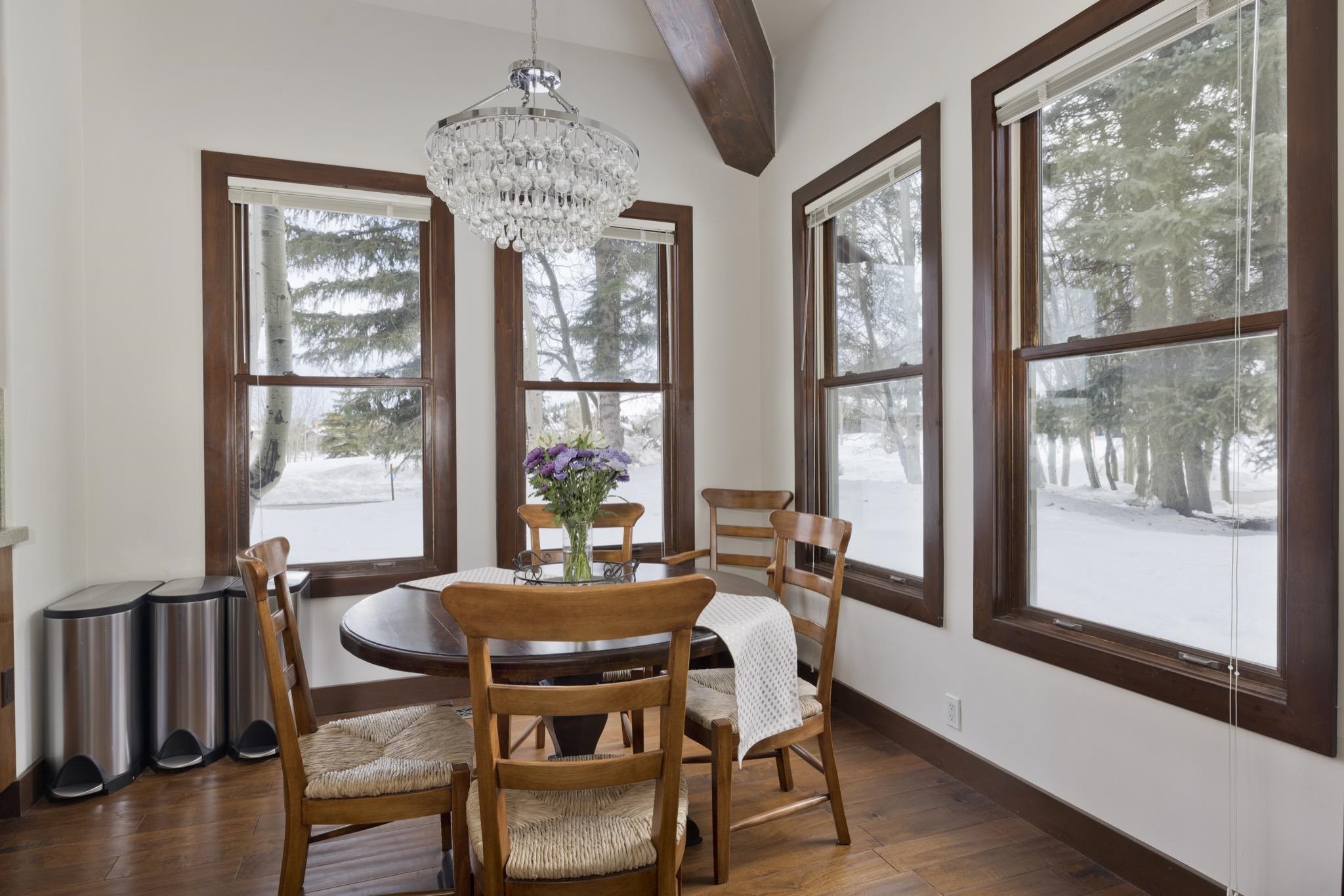 310 Ranch Road Mammoth Lakes, CA 93546 - Photo 10 of 40 Dining area featuring dark wood-type flooring, a chandelier, and beamed ceiling