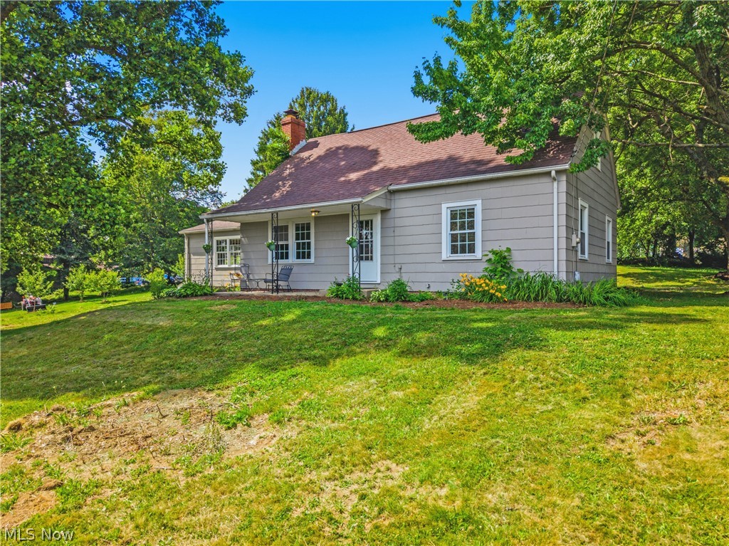 1769 Paradise Road Orrville, OH 44667 - Photo 2 of 36 Siding exterior with a covered front porch and a brick chimney