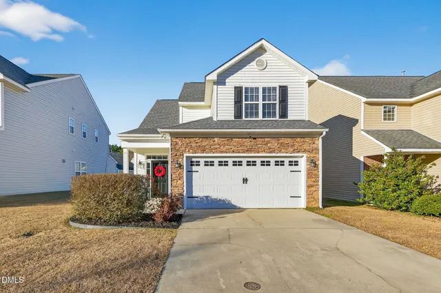a front view of a house with a garage