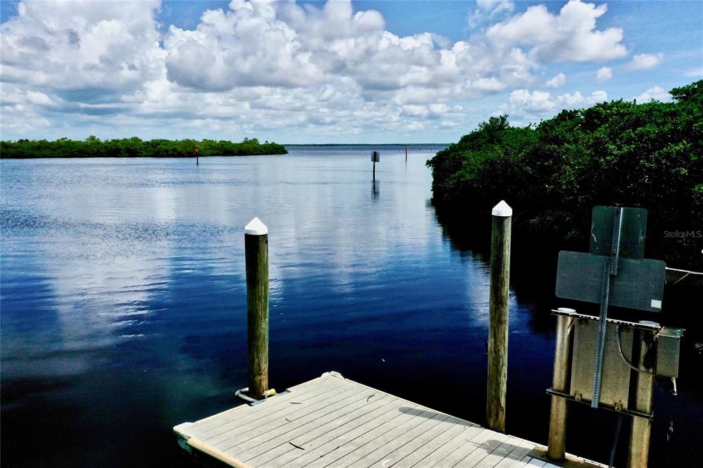 9357 Agate Street Port Charlotte, FL 33981 - Photo 17 of 17 a street view with wooden fence and lake
