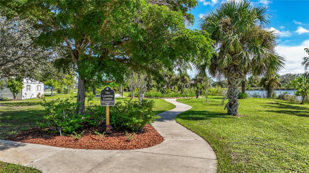 9357 Agate Street Port Charlotte, FL 33981 - Photo 4 of 17 a view of a garden with trees