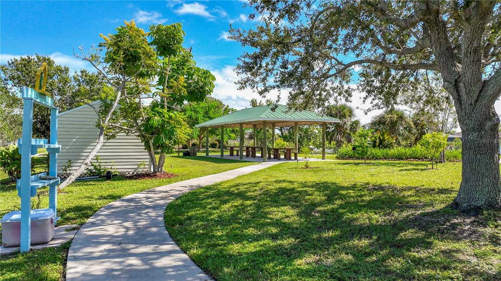 9357 Agate Street Port Charlotte, FL 33981 - Photo 5 of 17 a view of a swimming pool with a garden