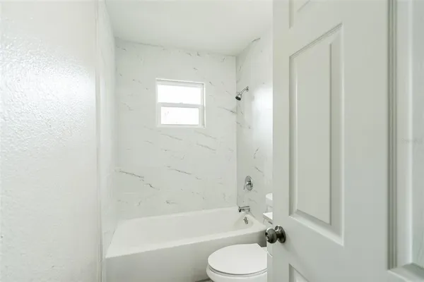 a bathroom with a toilet and a bathtub
