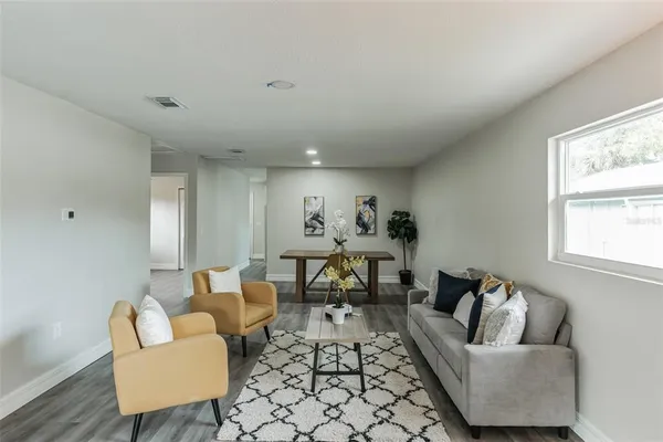 a living room with furniture and a large window