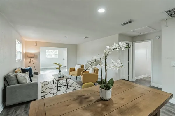 a living room with furniture and a chandelier