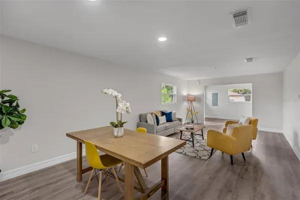 a view of a dining room with furniture and wooden floor