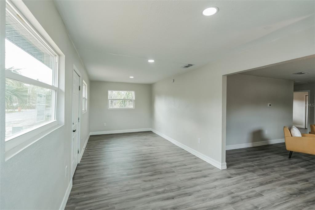 224 Singleton Avenue Arcadia, FL 34266 - Photo 10 of 24 a view of empty room with wooden floor and fan