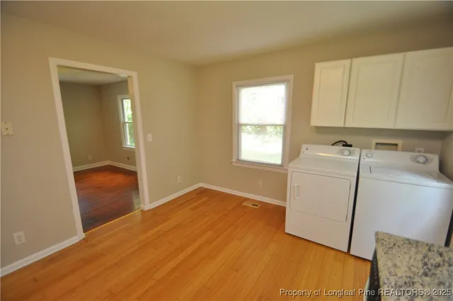 a view of storage and utility room with washer and dryer
