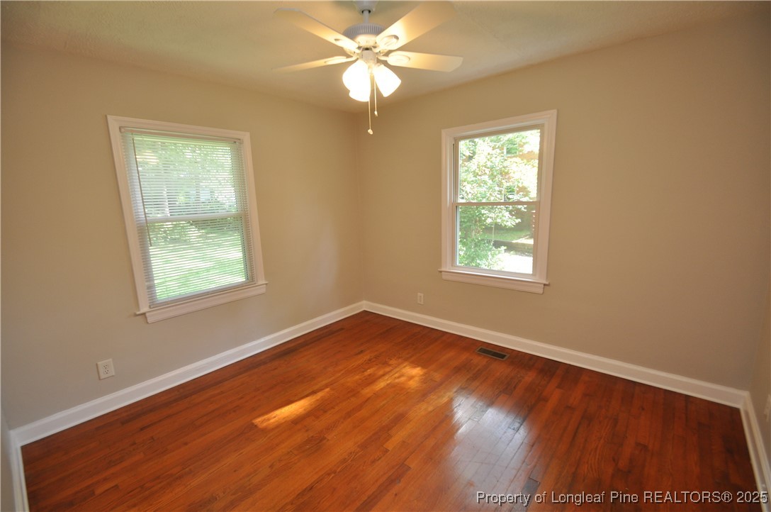 326 Webster Street Cary, NC 27511 - Photo 15 of 20 a view of an empty room with wooden floor and a window