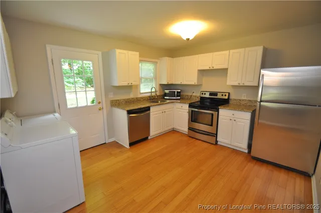 a kitchen with a sink a stove and refrigerator