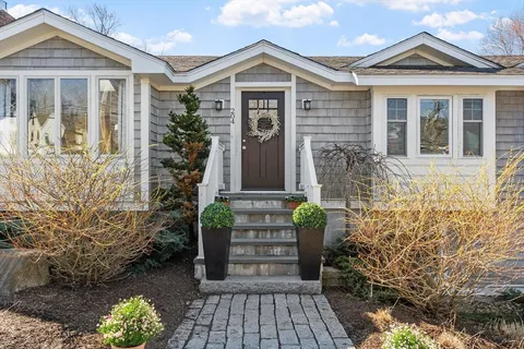 front view of a house with potted plant