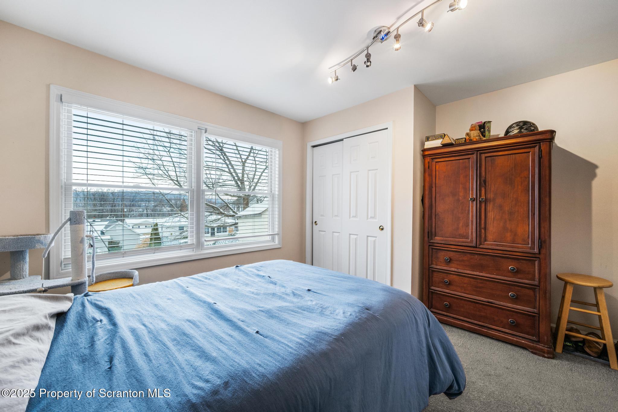 176 Poplar Street Archbald, PA 18403 - Photo 17 of 34 a bedroom with a bed and a large window