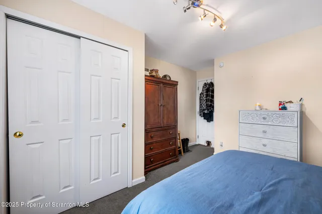 a bedroom with a bed and closet