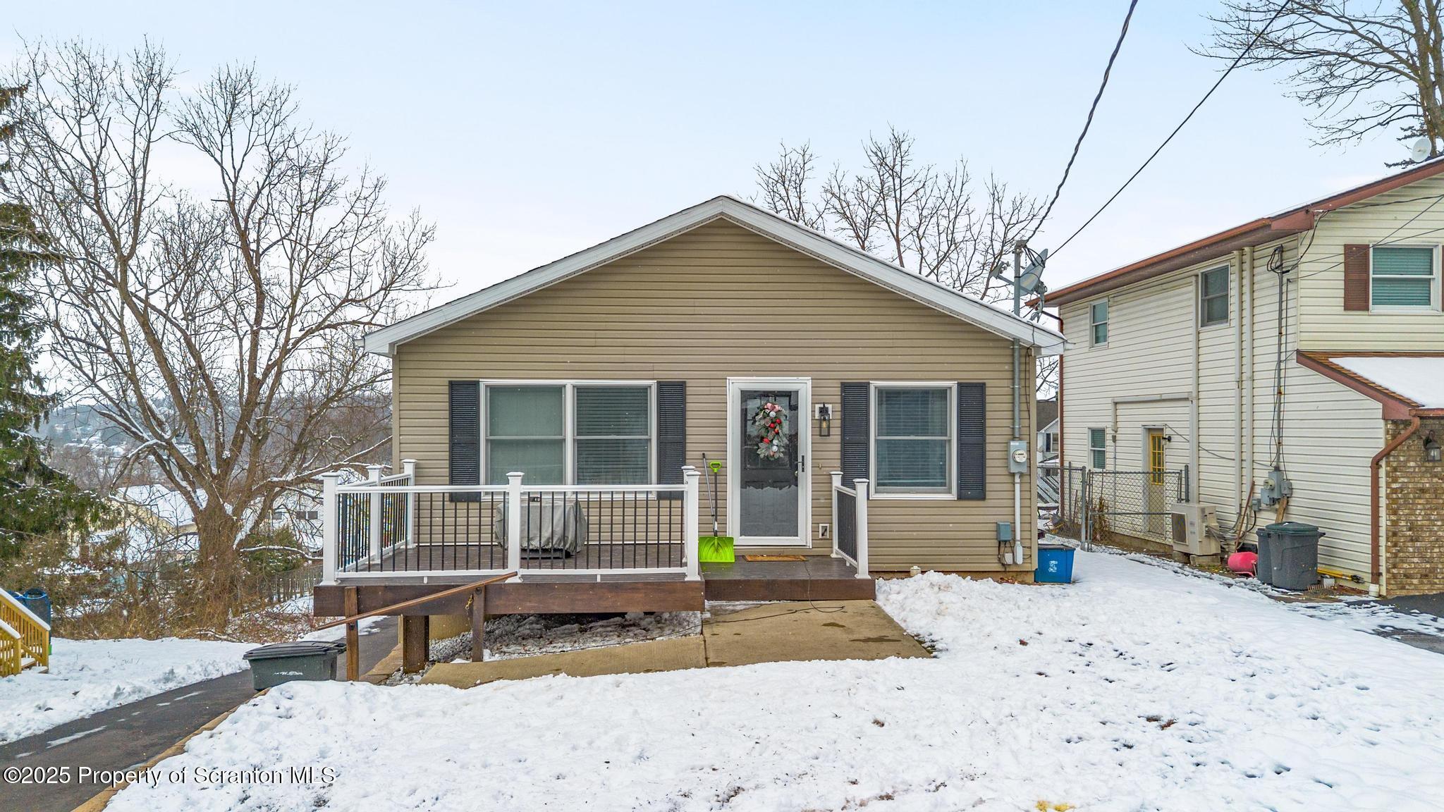 176 Poplar Street Archbald, PA 18403 - Photo 2 of 34 a front view of a house with a yard covered in snow
