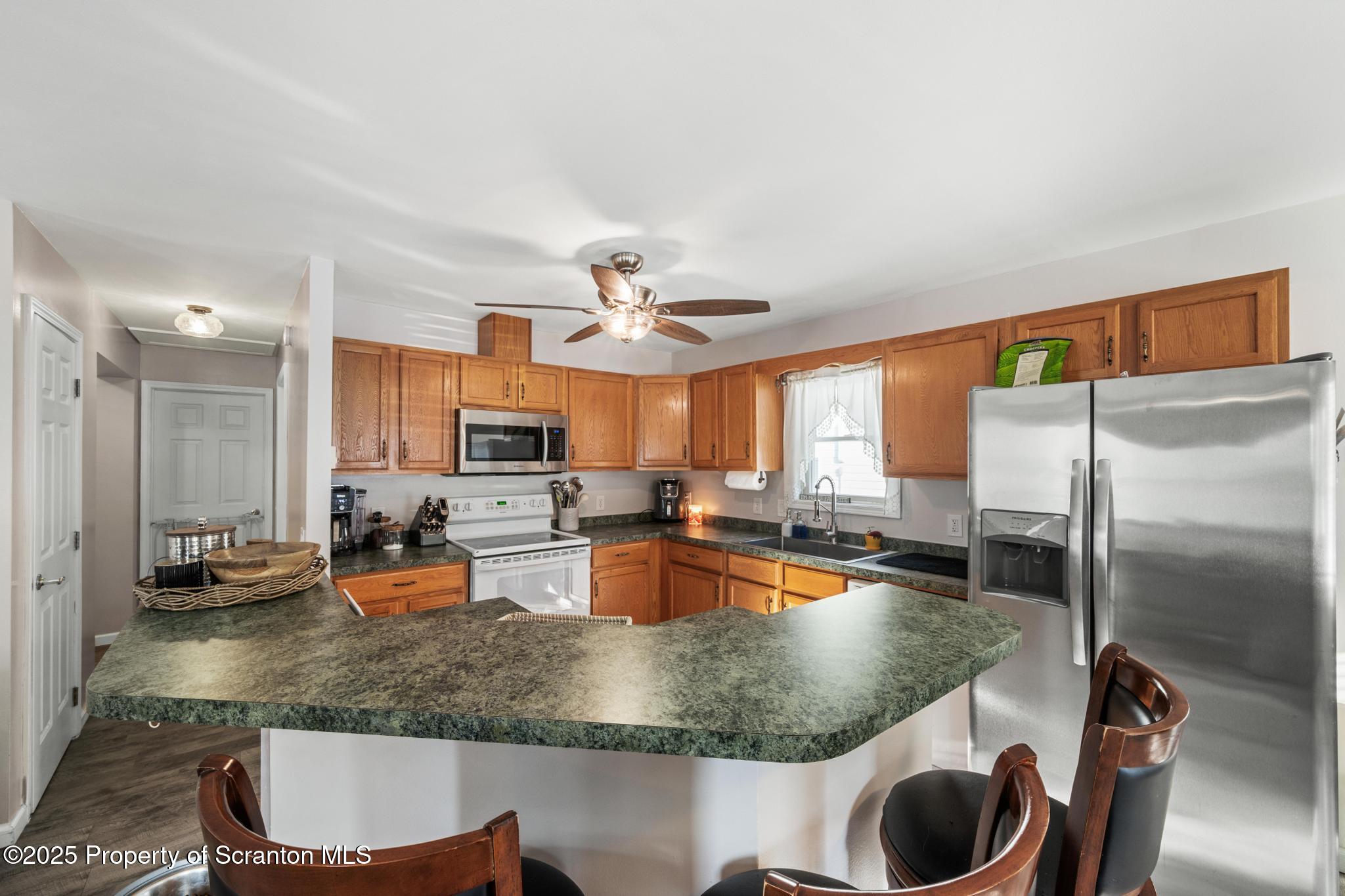 176 Poplar Street Archbald, PA 18403 - Photo 3 of 34 a kitchen with a stove a sink and a dining table