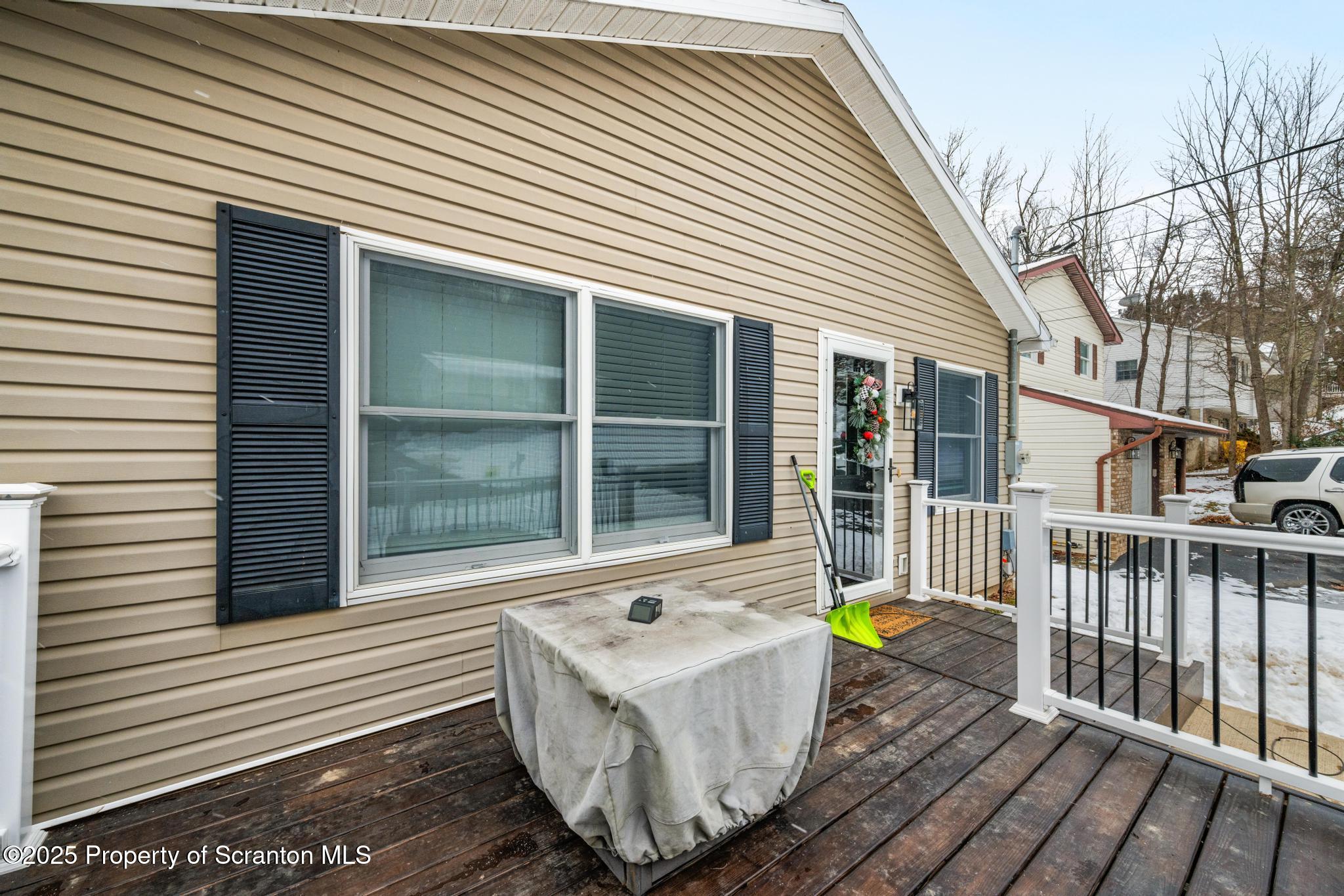 176 Poplar Street Archbald, PA 18403 - Photo 31 of 34 a white house with a table and chairs next to a yard
