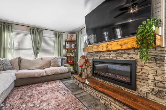 a living room with furniture a flat screen tv and a fireplace