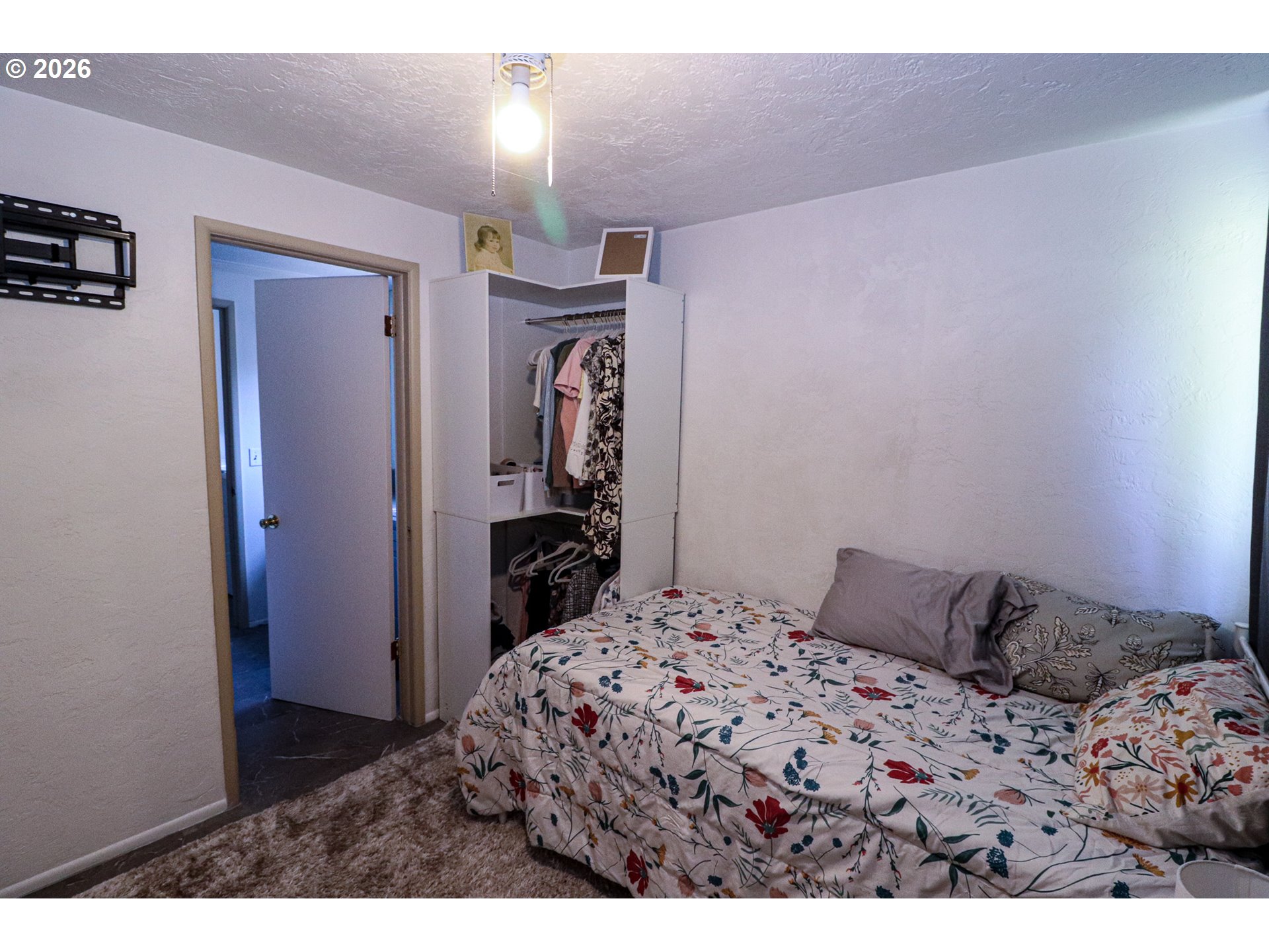 7077 Main Street Springfield, OR 97478 - Photo 26 of 34 a bedroom with a bed and a television