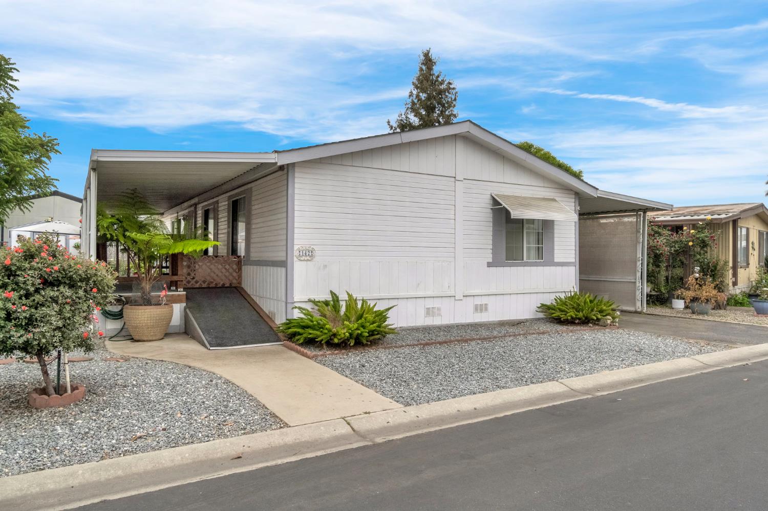 1218 East Cleveland Avenue, Unit 142 Madera, CA 93638 - Photo 2 of 32 a house view with a outdoor space