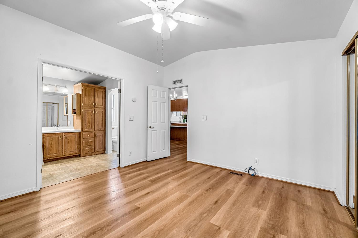 1218 East Cleveland Avenue, Unit 142 Madera, CA 93638 - Photo 23 of 32 wooden floor in an empty room with a window