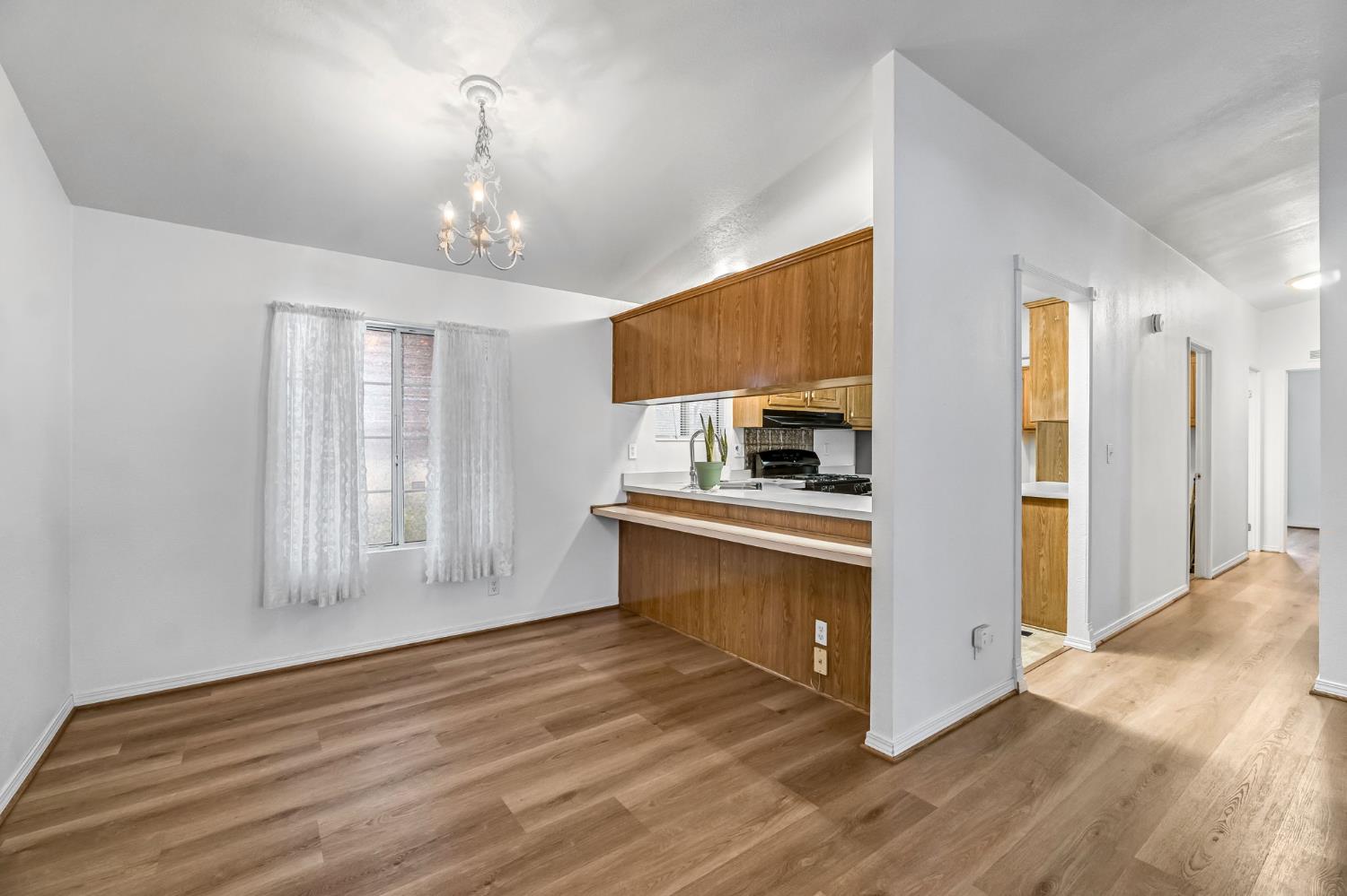 1218 East Cleveland Avenue, Unit 142 Madera, CA 93638 - Photo 9 of 32 a view of kitchen and kitchen with wooden floor