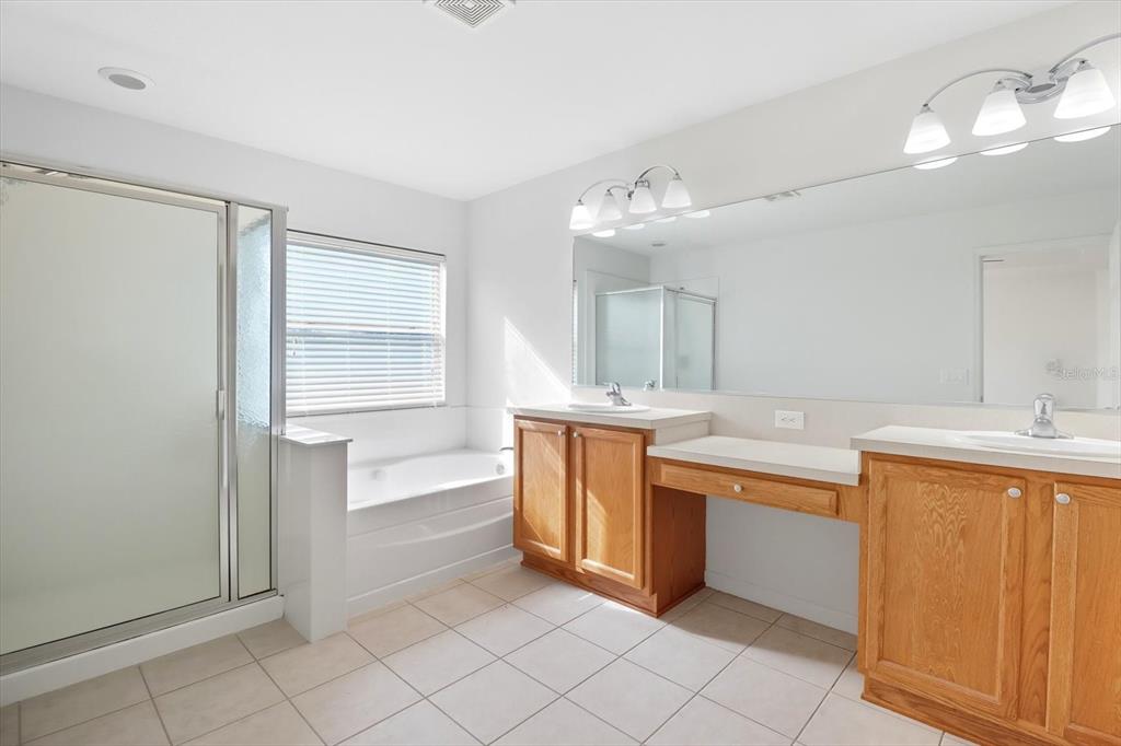 4059 Southwest 51st Road Ocala, FL 34474 - Photo 29 of 42 a large white kitchen with a sink and dishwasher a stove top oven with wooden floor
