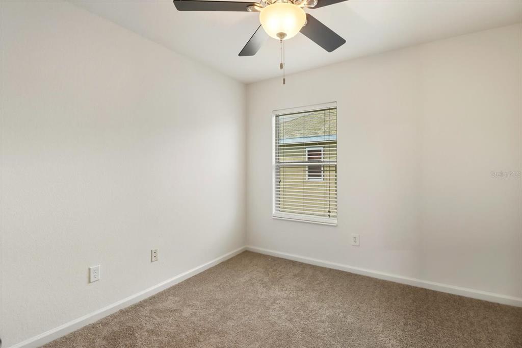 4059 Southwest 51st Road Ocala, FL 34474 - Photo 31 of 42 an empty room with a window and a fan