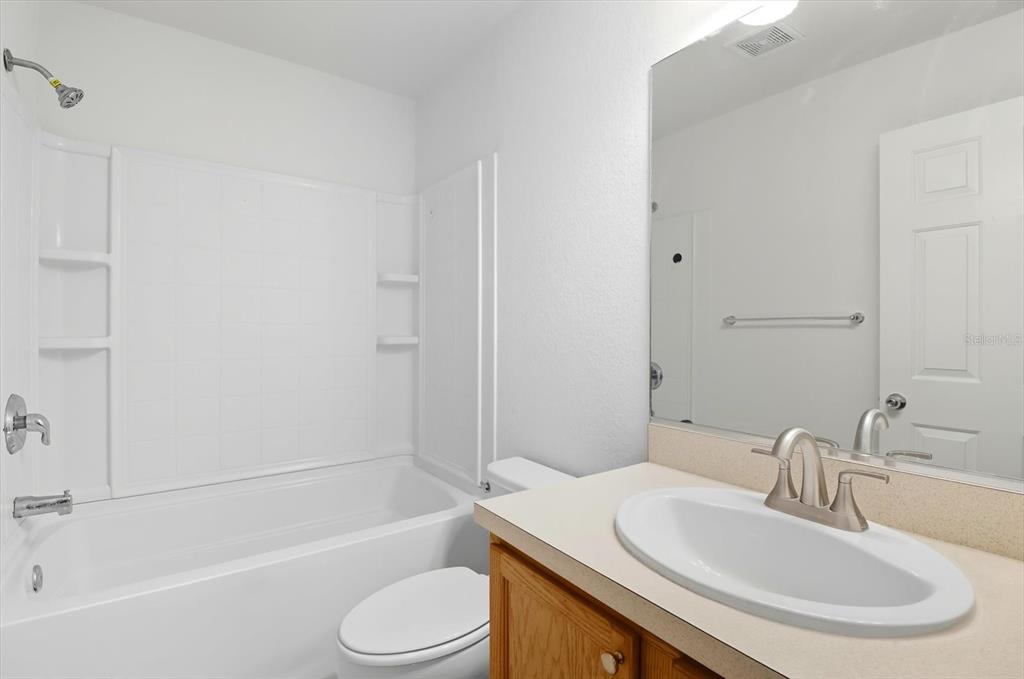 4059 Southwest 51st Road Ocala, FL 34474 - Photo 33 of 42 a bathroom with a sink toilet and a bathtub