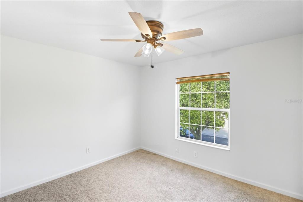 4059 Southwest 51st Road Ocala, FL 34474 - Photo 34 of 42 an empty room with a window and a fan