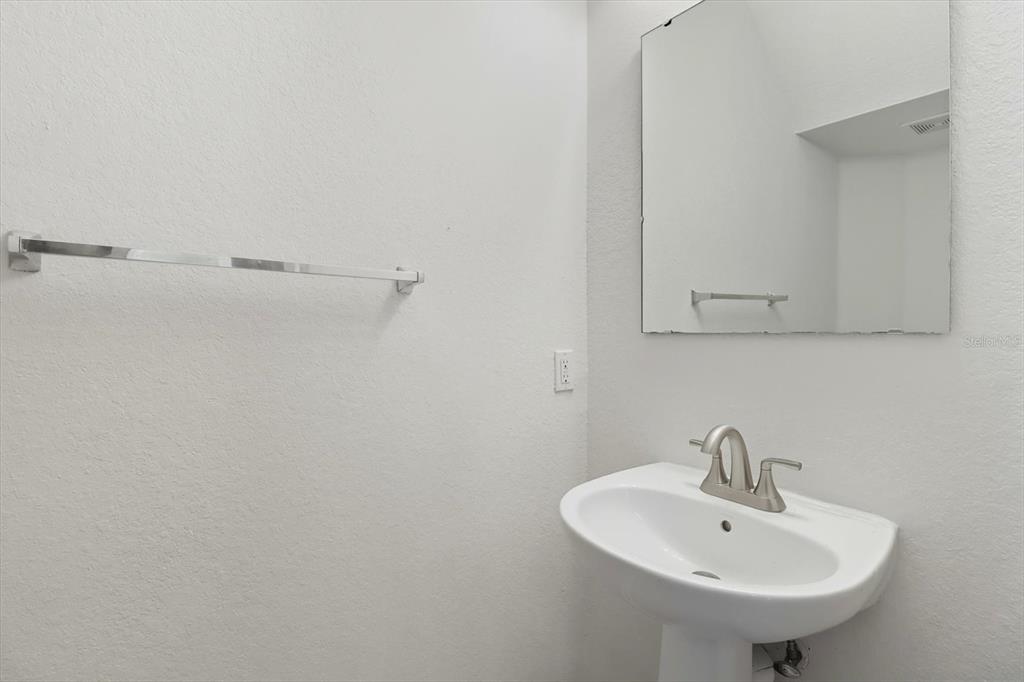4059 Southwest 51st Road Ocala, FL 34474 - Photo 10 of 42 a bathroom with a sink and mirror