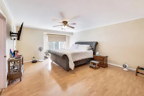 a spacious bedroom with a bed and a chandelier